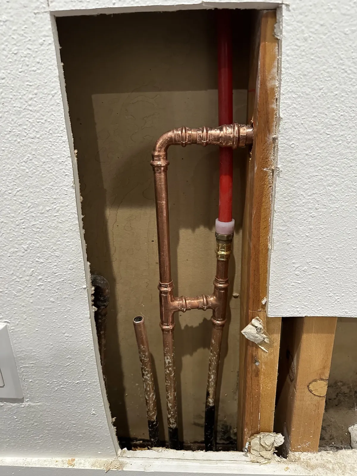 New copper and PEX supply lines inside an opened wall