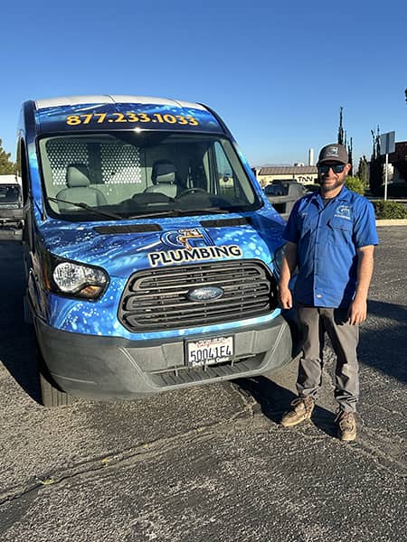 CH Plumbing technician with the wrapped company van on a service call