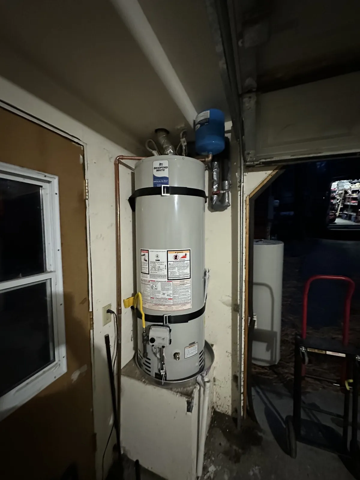 New gas water heater installed in a garage