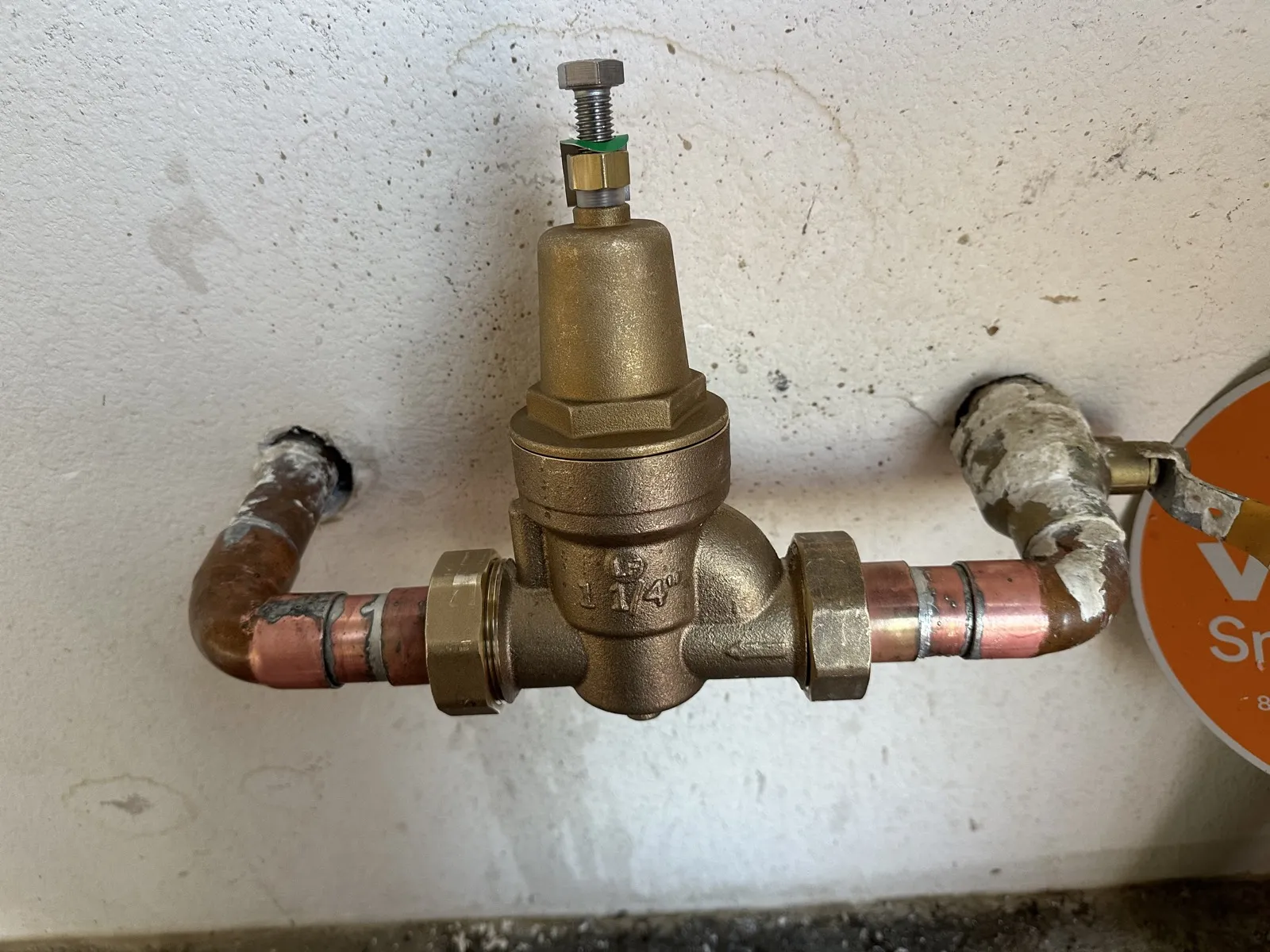 New brass pressure regulator installed on a home main line