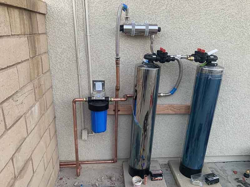 Whole-house water filtration system being installed