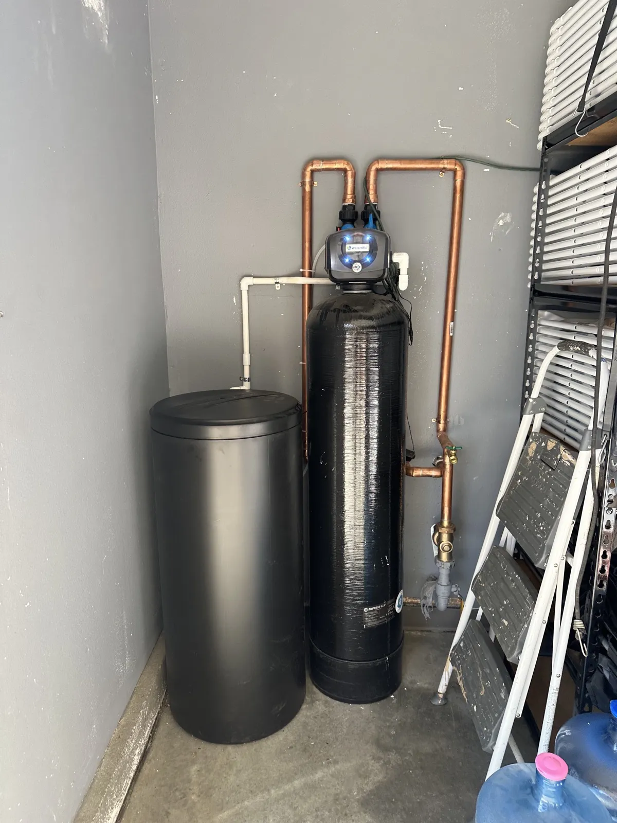 Water softener and brine tank installed in a garage corner